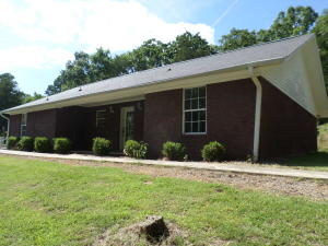 Nice home in excellent area just outside of Ozark. Wooded and secluded, above ground pool with deck, spacious home with a large laundry room,brick exterior, tile floors, landscape and centrally heated and cooled, excellent home in a great location, call for your showing today!