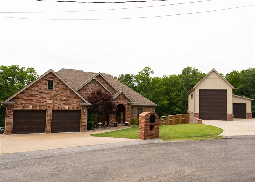 This stunning 2-story home, conveniently located minutes from HWY 71, includes a 1200sqft detached garage, perfect for your large RV with its 14' door. The main level features a split floor plan with an open living space and beautiful natural light. The upstairs kitchen includes upgraded stainless steel appliances, granite countertops, and plenty of pantry space. Just steps away from the kitchen is the stairway to an entertainer's dream come true. Designed with modern elements, you'll forget you're in the basement from the large windows to the 9' ceiling. this home is on a three-bedroom septic. The basement holds a full kitchen, built-in speakers, a projector, and a remote-controlled projector screen perfect for movie night or having family and friends over for the big game.