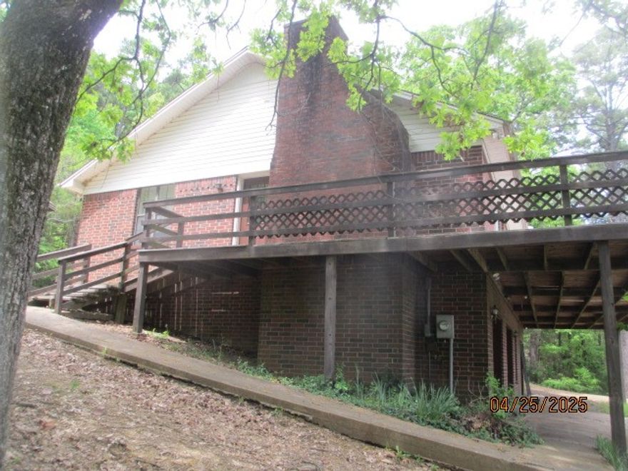 Gravel wrap around driveway, lower level 2 car garage, den with some kitchen amenities, dumb-waiter available to move grocery's from garage to main level, small office, fireplace with vented controls, large second level deck.