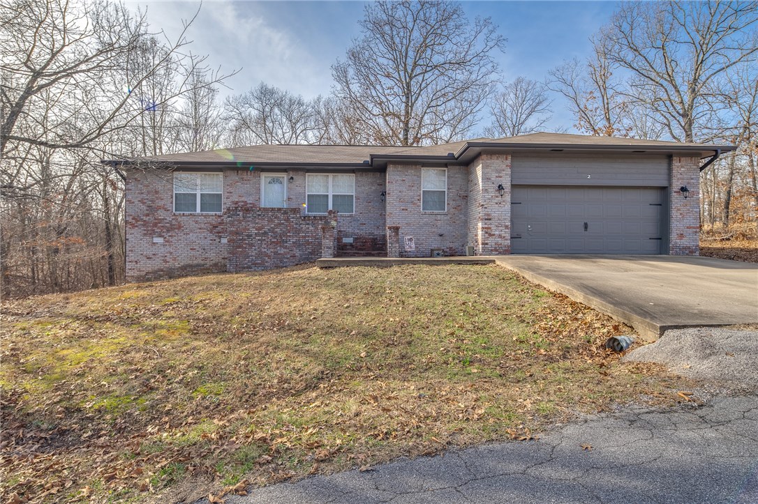 Cute and affordable home in Bella Vista! Close to Branchwood activity center. Enjoy all that Bella Vista has to offer. Common property strip of land to one side of the house. Great wooded view from the deck. Crown molding and wood laminate floors.