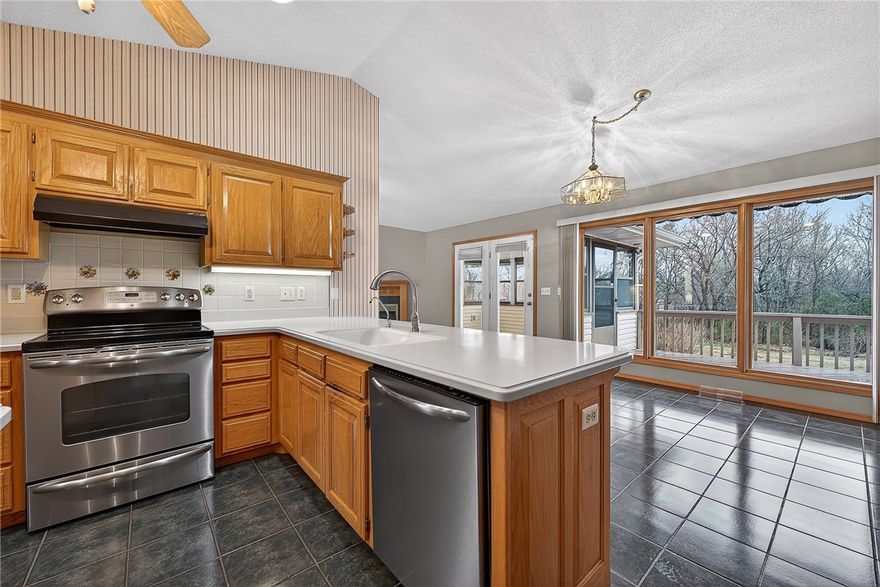 Located in the highly desirable Highlands area of Bella Vista, this beautifully maintained, one-level home offers easy living just minutes from Highlands Golf Course, Loch Lomond, and I-49. Step inside to a spacious, light-filled living room featuring a vaulted ceiling and an inviting layout designed for comfort and functionality. The split floor plan provides privacy, while the kitchen offers great everyday usability with a pantry, island, and built-in desk—perfect for organization or working from home. This home truly shines with its thoughtful extras, including abundant storage throughout and a cedar-lined closet. Relax and unwind in the 3-season enclosed porch, equipped with gas and electricity and reinforced for a future hot tub. Outside, enjoy a beautifully landscaped yard. The oversized 2-car garage includes a storm shelter, adding peace of mind. A perfect combination of location, functionality, and care—this home is ready for its next owner to enjoy.