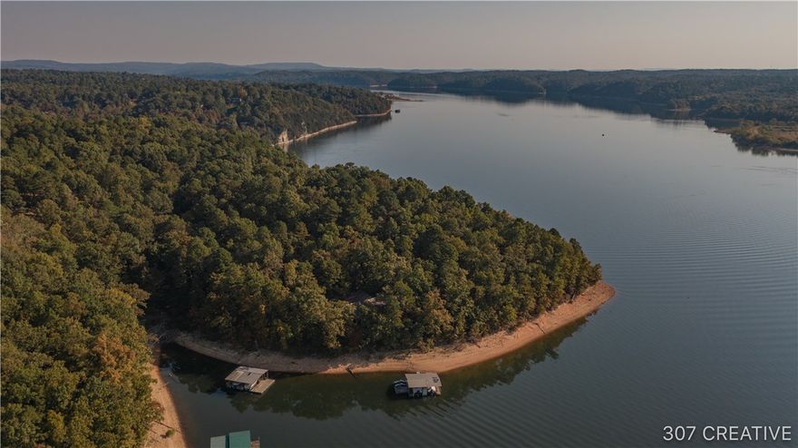 Under contract before print. Truly a one of a kind lakefront home situated on Esculapia Hollow inlet with lots of history and character. Lots of windows to provide exceptional year round lake views from almost every room, enjoy spectacular sunsets including a view of your private two slip dock. Lots of amenities and features like radiate floors, tiles painted by Giovanni Desimore (student of Picasso), James Lambeth designed home for Dr. Spock, lots of storage and potential. Completely updated kitchen and master bath as well as many other updates including new lower level composite decking. A place of peace and tranquility, privately situated on a point and place to call home, no restrictions and close to town. This property has it all!