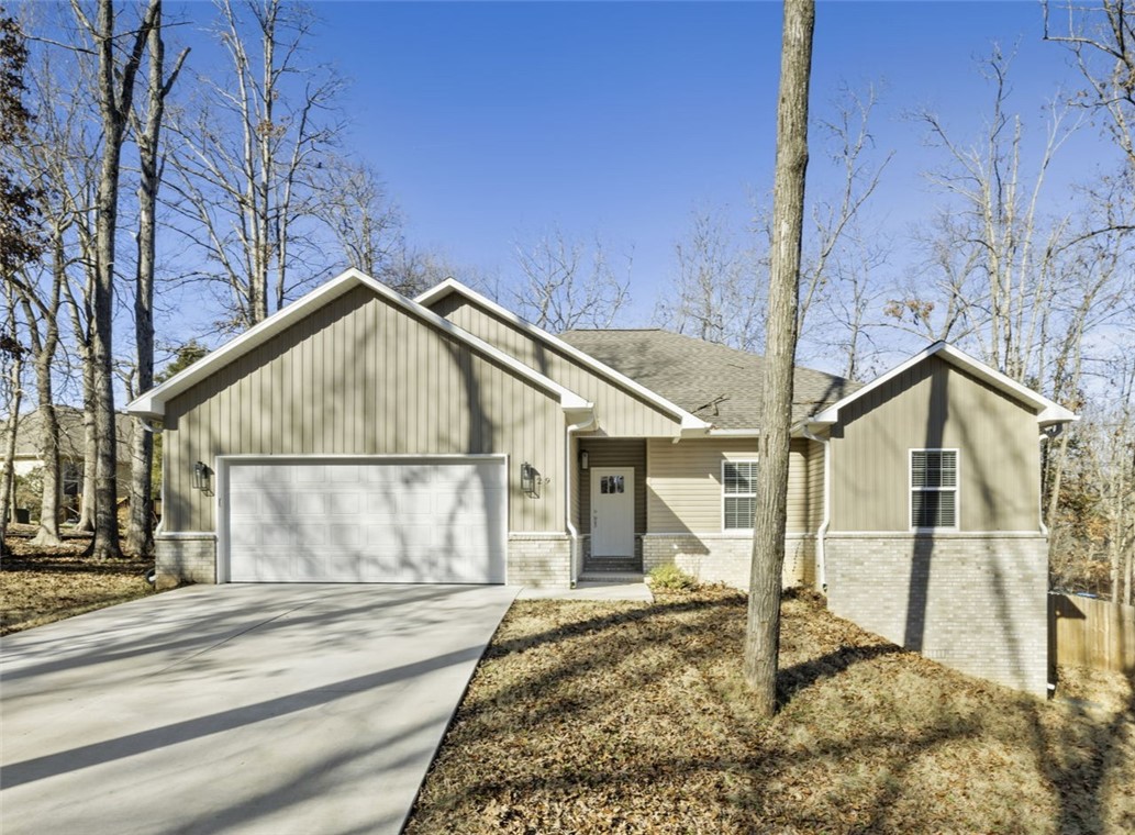 Welcome to a 4-bedroom, 2-bath home, built in 2022, and situated at the end of a cul-de-sac. An open-concept living area with tall ceilings creates an inviting space that seamlessly flows into the kitchen. The kitchen boasts quartz countertops, ample counter space, and modern fixtures, ideal for both chef's and entertainers alike. A spacious primary bedroom is complete with an en-suite bathroom featuring dual sinks and a generous walk-in closet. Three additional bedrooms provide flexibility for family, guests, or a home office, with one room offering built-ins for added convenience. Outside, enjoy the tranquility of the covered back deck—perfect for hosting gatherings or simply unwinding while surrounded by nature. Nestled in a wonderful Bella Vista location, this home offers close proximity to a variety of amenities all while providing a serene retreat. This home is RD eligible.