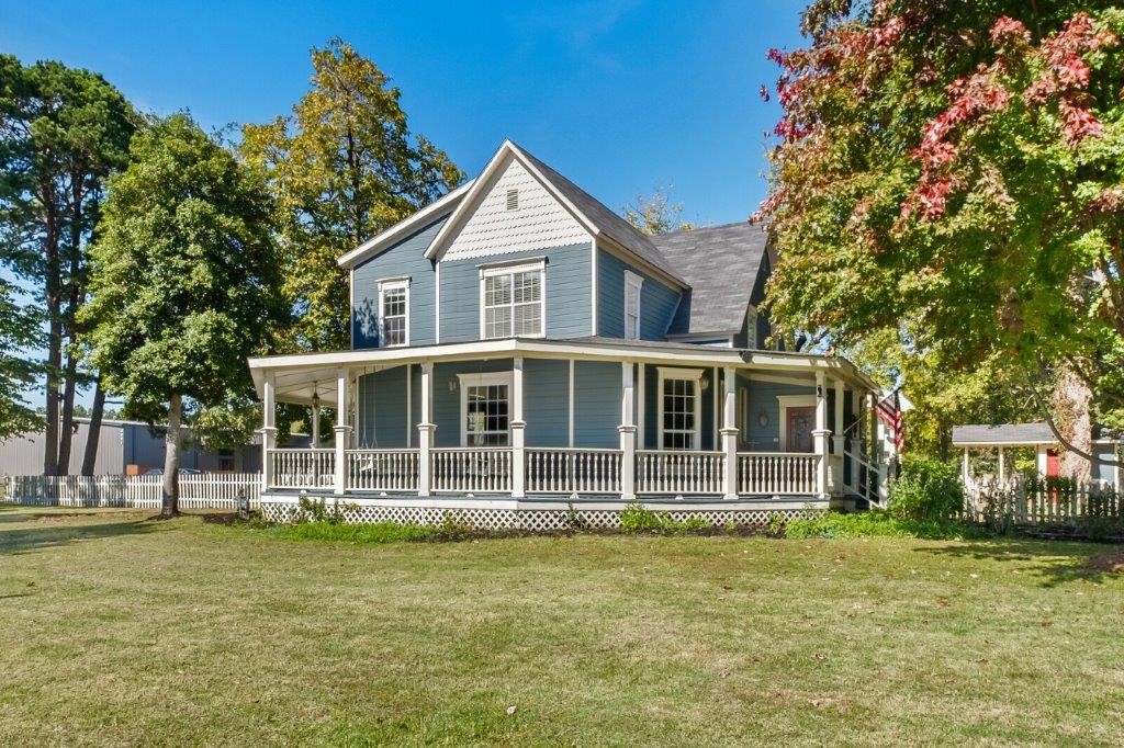 Historic Farmhouse Chic. This home has been beautifully restored but keeping historic charm of the time. Fall in love as you step onto the covered porch with your sweet tea and swing your stress away. As you enter the stained-glass front door and through the foyer you will notice the wood floors and tremendous detail in all the trim. First living area flanked by music room and library with fireplace. You will love all the natural light that floods the kitchen and breakfast. Warm up in the hearth room perfect for time with friends with its own private pergola. Upstairs complete with 4 bedroom and bath. Entertain in the yard on 2.5 acres boasting of fig tree, cherry, grape trellis, and large shade trees. The barn features guest quarters with downstairs living and upstairs bath and bedroom. Could be perfect for ABnB or rental. The shop with wood stove perfect for working on projects this winter and additional oversized 2 car garage. Your dreaming is over, its right here with so much to offer. Zoned Agri.