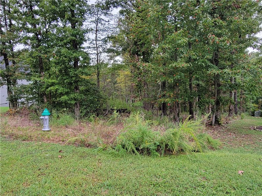 Large lot with excellent perc test results for a 3-bedroom septic system!  The front half of the lot has only a mild slope and would make a great building site for your new home.  Behind the lot is wooded common area providing privacy and a peaceful setting for your connection with nature.  Located near Lake Anne and close to mountain bike trails, including The Back 40 and Sbat trails.  Go check out this lot to see if this is a good place for your new home.  Bentonville schools.