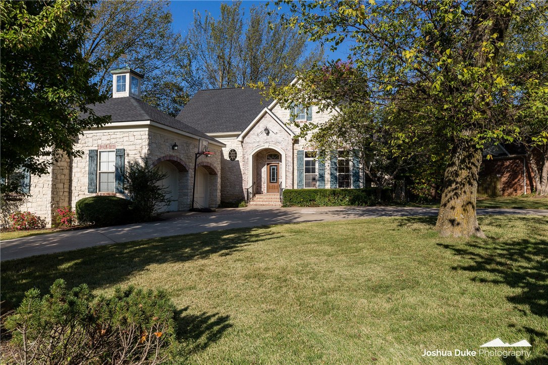 Custom European style home with limestone exterior on corner landscaped lot, beamed ceiling, stacked stone FP, glazed cabinetry, 10x30 covered back porch & privacy fenced. Hardwoods on main level, Vandergriff school.