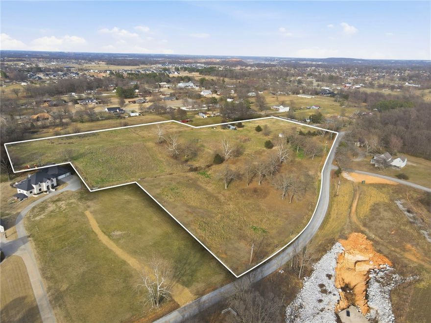 Rare opportunity in Elm Springs-14.43 scenic acres with open views of Elmdale Lake. Gently rolling and picutresque, this property is ideal for a private luxury estate or a builder's showcase project. Peaceful setting with endless potential.