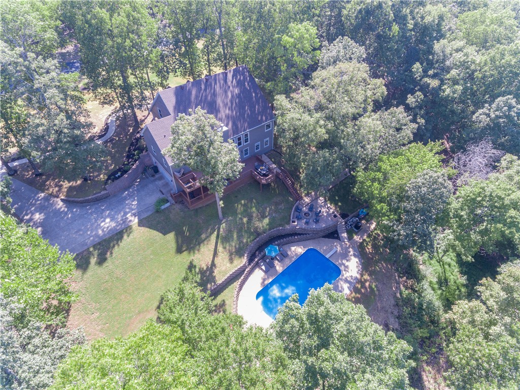 Stunning lakefront home in the sought after gated community of South Mountain Estates! This home literally has it all! Lake view, slip in community dock, boat lift, and inground 20 x 40 pool on 2.5 acres! Home features a spacious open/split layout, master on main level, huge walk out basement with kitchenette and island bar, 2 large decks over looking the lake, spiral staircase, fire pit area with pool and lake view, covered front porch, all new windows on main and upper level, new pool heater, new UV filtration system on pool, new sand in pool filter, wired for hot tub, and so much more!!