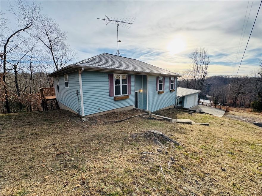 Escape the everyday in this spacious, secluded Beaver Lake retreat! This retreat is surrounded by serene views, eagles soaring overhead, deer and wildlife roaming nearby, and the kind of profound quiet that comes with squirrels as your neighbors. This inviting 4-bedroom, 3-bathroom home offers dual living areas for family gatherings or quiet relaxation, plenty of room to spread out. The seller has completed several updates since 2023 including a new HVAC system, garage doors with frames, upstairs refrigerator, fresh flooring in the kitchen and primary bedroom, and a Culligan water treatment system..and that's just to name a few. Unwind in the sun-drenched Sunroom, the ideal spot to sip coffee and let the world’s cares melt away, or gather on the expansive back decks to take in the views of the lake and wildlife by day and the shooting stars, and constellations a plenty at night! All of that to simply say that a piece of Heaven is now for sale.