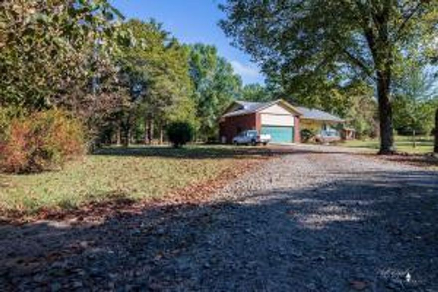 6x38 front porch, 12x16 covered patio, 14x20 utility building, detached patio in backyard, rock lined drainage with small 2 small ponds,  apprx 2 acres of woods behind house.  roof is new architectural shingles, h/a replaced last year. Well built home with great privacy, all fencedwith just the right amount of trees and landscaping, detached patio and firepit make entertaining fun and easy.Property front and sides are fenced but not all way to back.  Across the back property line is a gas line easement which is always kept mowed, that is how you know you are at back line