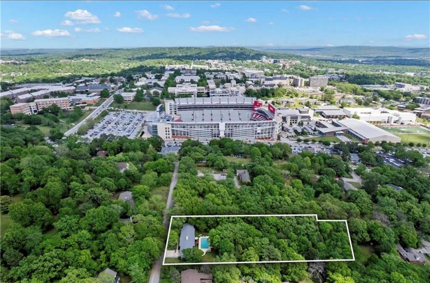 Don't miss a chance to own a piece of Fayetteville History- steps away from the Razorback stadium! Welcome to this beautifully remodeled 3-bedroom, 2-bath home, perfectly situated just steps from Razorback Stadium on a sprawling 1.15 acre lot. Originally built with timeless charm and updated in 2017 , this one of a kind residence was proudly added to the National Register of Historic Places in 2023. Enjoy summers with a private in-ground pool, outdoor shower, and a separate outdoor bathroom- an entertainers dream! The brand new deck offers the perfect space for gatherings, tailgates, or simply relaxing. Weather your looking for a game day getaway, a full-time residence, or a piece of local history- this property offers it all!