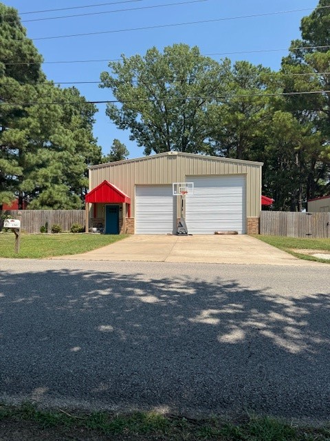 Custom, Red Iron Building Home on .33 AC +/-! This 3BR/2BA - 2,184 SF open layout home boasts granite counters in the eat-in kitchen and concrete floors throughout. The primary bedroom is large and has a nice walk-in shower, walk-in closet and double bowl sinks. There are 2 additional bedrooms of a nice size along with a second full bath that also contains a walk-in shower and double bowl sinks. There is a bonus loft area that would work great for a library/study/office. Outside on the large lot you will find mature trees making for perfect shade and a fire pit for warmth on a cool night. The back covered patio contains an outdoor kitchen area, making it a nice spot for entertaining. There is also a 200 SF storage building for all your lawn care equipment. Don't miss out on the feel of country living with the ease of shopping/dining within minutes!