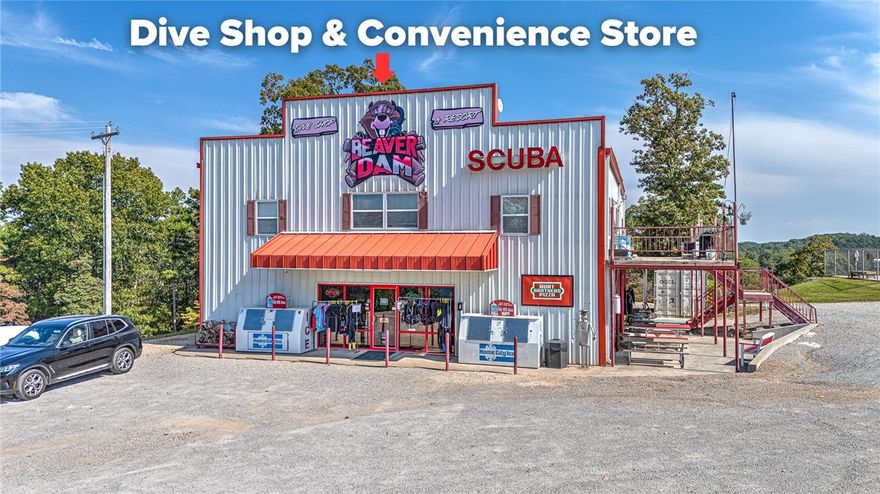 Here’s your opportunity to own a thriving lakeside business on the sparkling waters of Beaver Lake! Situated on 14.47 acres with over 975 ft. of major frontage and breathtaking views of Beaver Lake, this property is home to the region’s #1 PADI Dive Center—Beaver Dam Dive Shop—located at a nationally recognized diving destination. The business features gear sales and rentals, classes for every level of diver, and an array of lodging choices including 27 RV campsites, a remodeled motel, bunk rooms, and hostels—all ready to welcome adventure seekers. On-site, you’ll also find a convenient store stocked with food, beverages, and sundry items, serving up delicious Hunt Brothers pizza for divers and travelers alike. The property offers plenty of parking for guests, campers, and boaters, along with trickle chargers for boat batteries. Whether you’re looking to dive, camp, or invest in a well-established lakeside enterprise, this property offers a rare opportunity to own a proven and profitable destination on Beaver Lake.