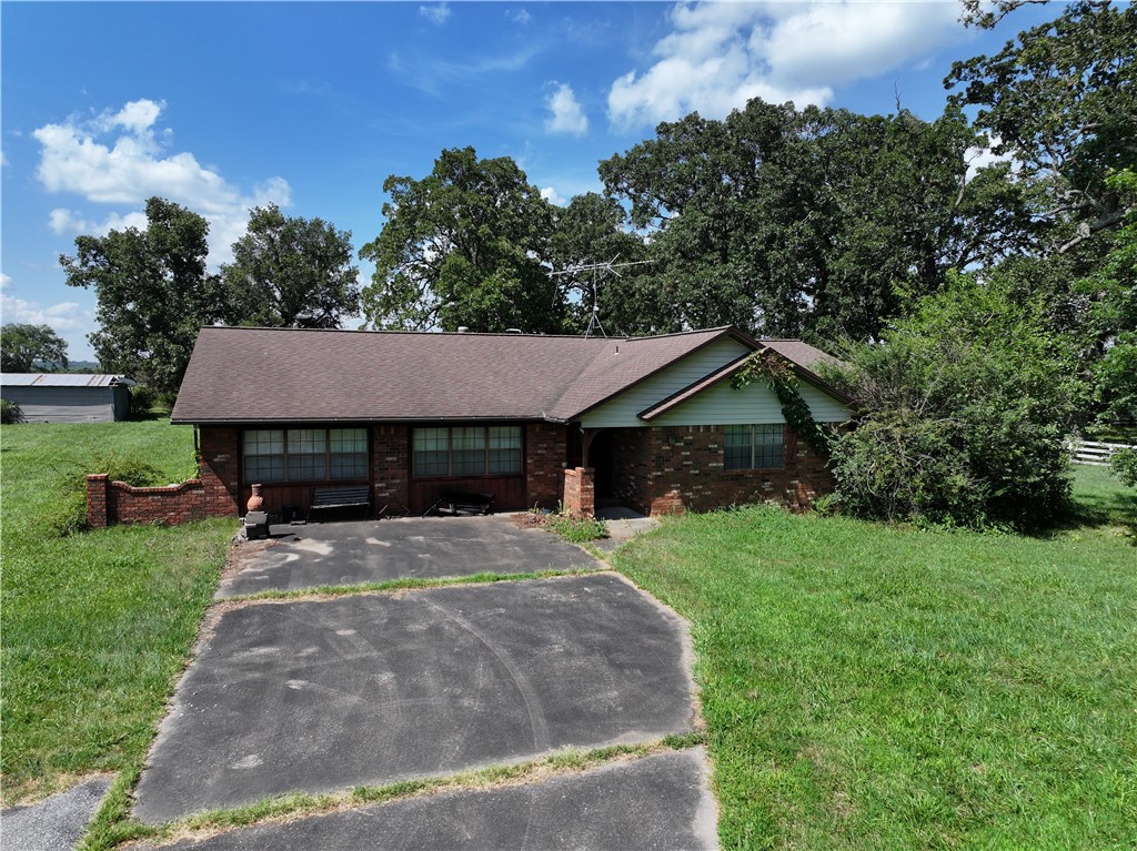 Attention all investors! The property's proximity to Lincoln makes it a fantastic opportunity for developers looking to build new homes in a growing community. There is road access on 3 sides of the property. Nestled on a sprawling 12.73 +/- acres just 2.5 miles outside of charming Lincoln, AR, this spacious 2,663 sq/ft home offers endless possibilities for comfort, development, and investment. Built in 1980, this property combines rural living with the convenience of nearby town amenities. This 3-bedroom, 3-bathroom home boasts a large, open-concept living room and kitchen, perfect for family gatherings and entertaining. The former garage has been thoughtfully converted into a versatile bonus room, ideal for use as a home office, studio, or extra living space. The flat, accessible land includes a shared pond. With road access on three sides and a long driveway leading to the house, the property offers both privacy and potential for subdivision or additional building projects.