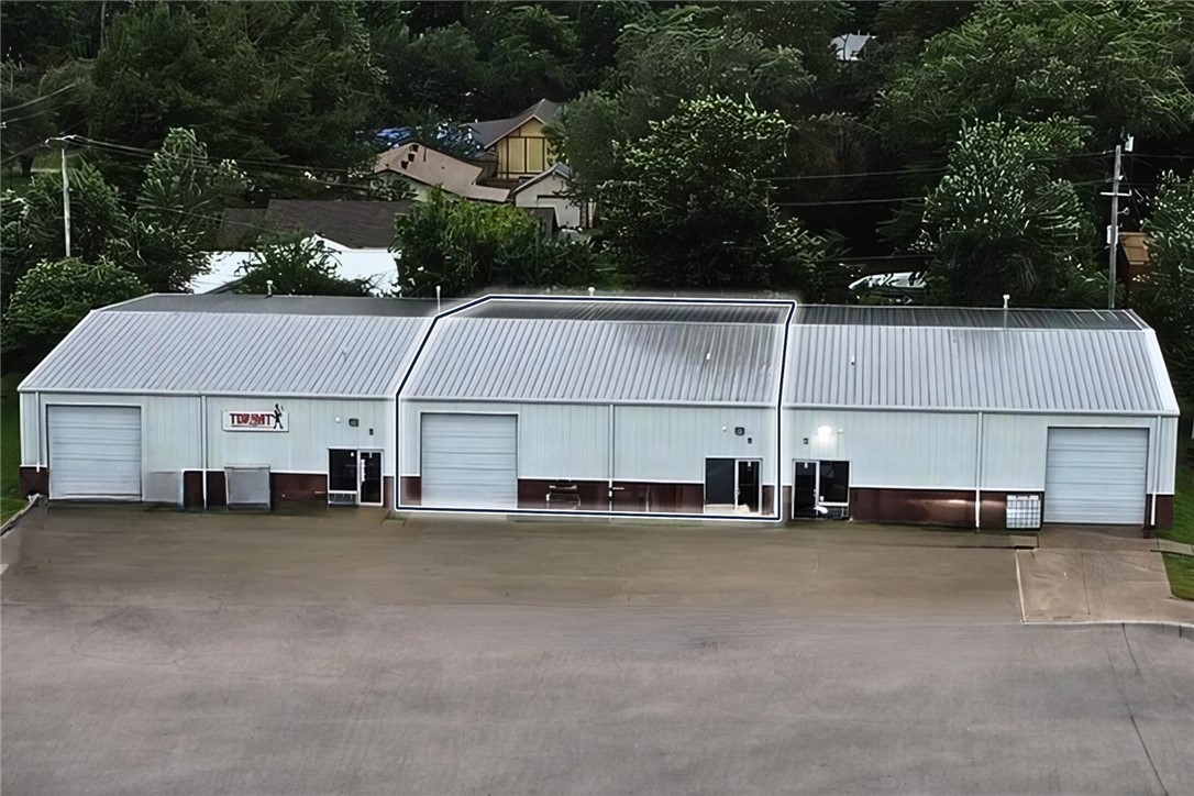 One 10' bay level door. 13' clear height and 17' peak height. One small office and one bathroom. Less than a mile away from us, 71-b. 3.4-mile drive to i-49