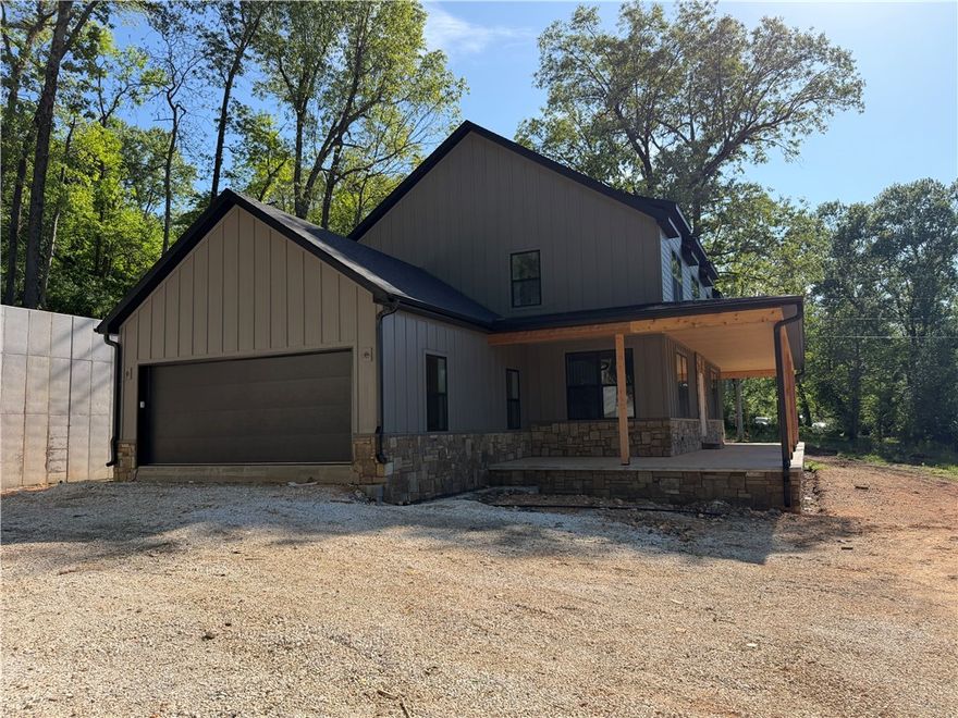 This beautiful new home built by PMI construction offers a wonderful blend of space, privacy, and modern comfort. With two thoughtfully designed stories, this 4 bedroom, 3.5 bath (plus an office) home provides room for everyone to spread out while still feeling warm and inviting.
The primary suite is conveniently located on the main level, with a well-appointed bath and a nearby half bath for guests. Upstairs, you’ll find three spacious bedrooms plus an office/bonus room. One of the upstairs bedrooms is oversized and could easily serve as another bonus room, media space, or playroom.
Start your mornings on the expansive front porch, perfectly sized for porch swings and slow coffee mornings, and unwind in the evenings enjoying peaceful views. Upstairs, a private rear deck offers direct access to the upper portion of the property — ideal for exploring, entertaining, or simply enjoying the extra space. Come see it!