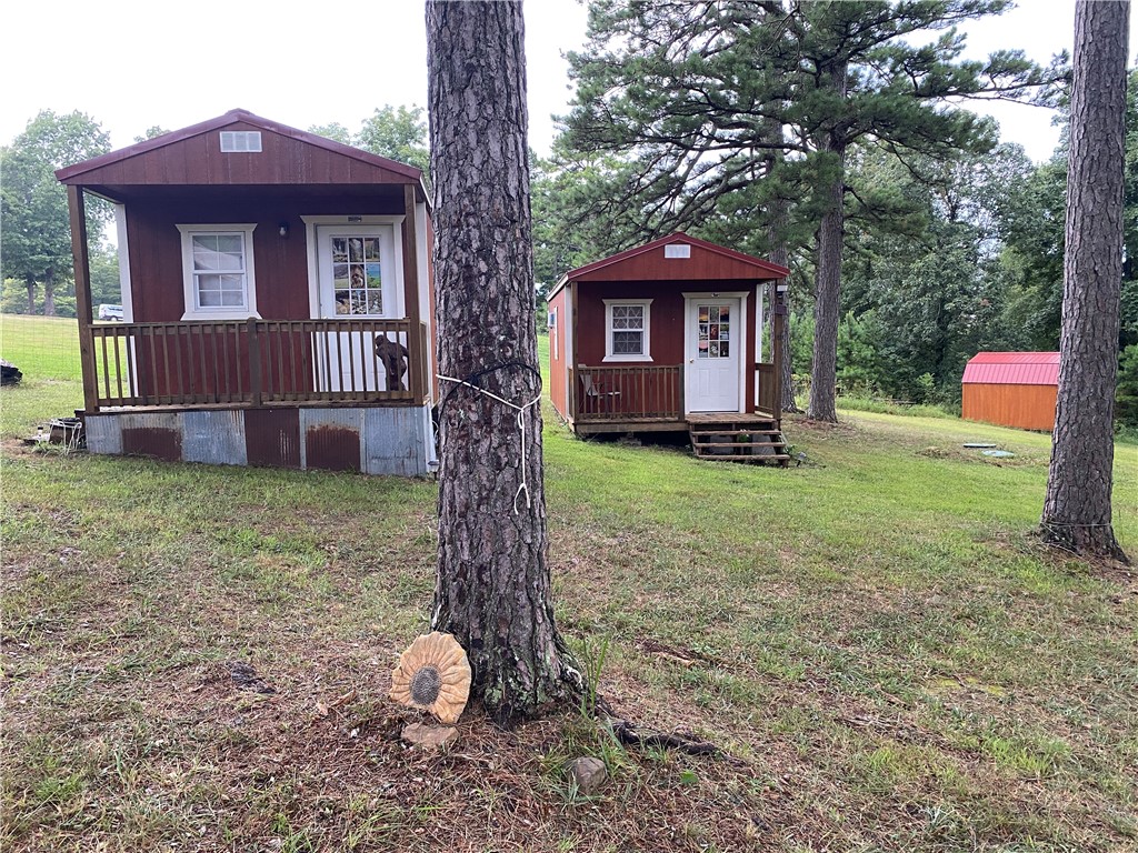 Awesome opportunity with 6 tiny homes setup up for your family get-a-way, nightly rentals or to use for your home. Property is located in the Mt Sherman Community between Jasper and Ponca. Strategically situated near the the junction of Hwy 74 & Kyles Landing Rd (5 mi from Jasper) near Kyles Landing Access Point/Campground (2.6 mi) & Triple Falls Waterfall. Located on 2 ac in the Upper Buffalo River Region of Newton County. Electric, new septic tank and rural water on site. Buildings include a 16'x12', two 16'x11' (with 4' porches), 13'x11' (with 4' porch), two 18'x16.5' Amazon boxes, and a 16'x11' storage building. Near the Ozark National Forest. Just a short drive from Russellville, Harrison, & Fayetteville. This central location is convenient to the best swimming holes, hiking, bike riding, canoeing, wildlife photography, ATV riding & fishing. Other nearby outdoor activities include horseback riding, mountaineering, caving, & scenic driving.