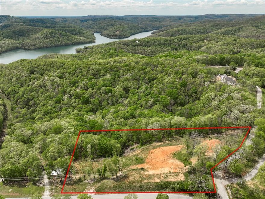 Dreaming of peaceful lake living? This 2.65-acre parcel offers serene surroundings and beautiful Beaver lake views, perfectly set up for your dream home or investment property. The dirt work is already complete, with multiple level building sites ready for construction. Water is onsite, and electric is at the street—just bring your plans and start building! Whether you're envisioning a custom home with a shop, a vacation getaway, or even multiple homes, there's plenty of room to make it happen. Located just 3 minutes from Beaver Lake, Indian Creek Park and boat launch, and only 5 minutes to Dam Site Park, this lot gives you easy access to outdoor recreation and the lake lifestyle. Conveniently situated between Rogers and Eureka Springs, enjoy an easy commute, with quick access to dining, shopping, and entertainment in historic Eureka Springs.