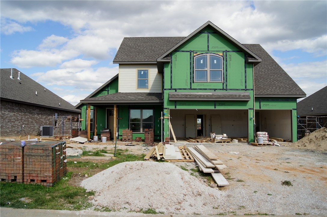 Stunning New Construction by North Rock Builders. This 4 bedroom, 2.5 bath, 3 car garage home is located in Bentonville School District and features custom cabinets, stainless appliances, vaulted ceilings, granite tops, custom tile shower, oversized jacuzzi tub, walk-in closets, hardwood flooring, crown molding, structured wiring for security and surround sound, central vac, gas fireplace, covered patio, gas cooktop, landscaped yard, and much more.