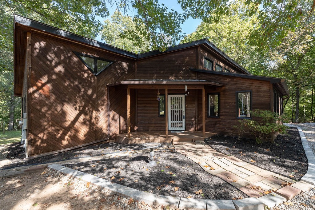 If you are looking for your own private oasis just minutes from Fayetteville, look no further! This unique 3BR/2BA - 1,646 SF cabin sits on 2.43 beautiful acres. The lot features a trail through the woods where you can enjoy wildlife, peace, and serenity. The home is a spacious midcentury style cabin with amazing charm and incredible potential. Crawl space remediation completed 10/2023. New roof, updated HVAC duct work and electrical upgrades have been done. The deck and all the exteriors have been refinished and painted. Don't miss this opportunity to have your little slice of heaven in NWA!