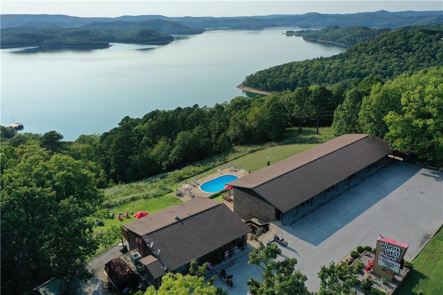 Incredible investment opportunity in the Ozarks! This iconic and well-maintained 23-unit motel offers stunning views of Beaver Lake and is located just minutes from Lake Leatherwood and the Beaver Dam. Trip Advisor ranked Pointe West Resort #1 for 8 years vs their 35 local peers. Each unit features a unique theme, creating a memorable guest experience that drives strong, repeat business year after year. The property includes on-site manager’s quarters, ample parking, a swimming pool, and peaceful natural surroundings. Guests return for the charm, the scenery, and the unmatched location—perfect for boating, fishing, biking, and hiking. With loyal clientele and a reputation for meticulous upkeep, this turnkey motel offers stable income and growth potential. It’s clear from the moment you step on-site—the owners take pride in every detail. Don’t miss this chance to own a profitable piece of paradise in Northwest Arkansas!