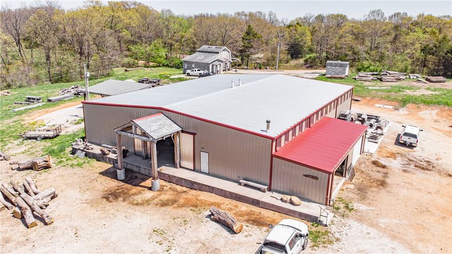 Don't miss this high-visibility commercial property on Hwy 62! With around 8 acres of flat, cleared land, this property offers a 9,000 sqft shop, updated and ready for your next venture, plus a cabinet-making shop. The property also includes a house and outbuilding, adding even more potential for future use. Act now to seize this unique opportunity—property only, business and equipment are not included. The current owner will lease back the property for 6 months. Business is for sale, but offered under separate terms.