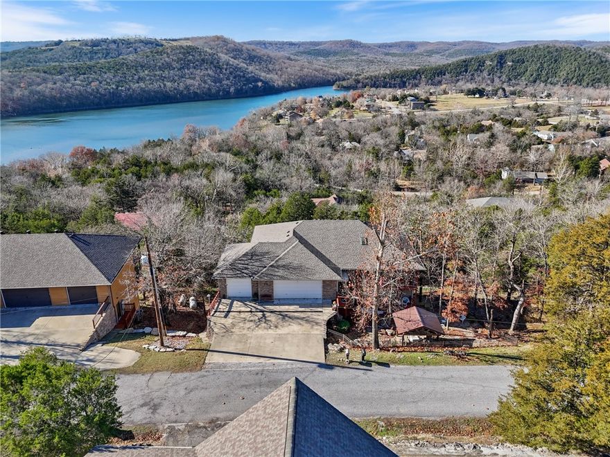 Discover stunning lake views in this beautifully updated 5-bedroom, 3-bath home offering 3,475 sq ft of comfortable, spacious design. Perfectly situated to capture gorgeous views from nearly every window. A large, updated kitchen anchors the main level, offering abundant cabinets and counters for everyday living or entertaining. Home features two high efficient American Standard heat pumps with upgraded air filtration system. You’ll also find a whole-home generator for peace of mind.This floor plan includes a large rec room with fireplace, inviting living area, and two oversized bedrooms. The unfinished basement is already framed and floored, providing a head start for future expansion. Outdoor living shines with flagstone patios and covered decks, perfect for enjoying the serene surroundings. The fenced yard adds convenience for pets or play. A 4-car garage, encapsulated crawlspace w/ sump pump and dehumidifier are just a few more updates. Spacious, updated, and positioned to take in breathtaking views!