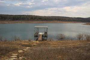 Located on Beautiful Bull Shoals Lake is the 4 bedroom, 3 bath home. Whether you are looking for a permanent home or vacation spot, there is room for everyone. Enjoy the large deck, well kept yard, 2 storage buildings and 1 stall boat dock. There is a large wood fireplace to cozy up to on those cool evenings including a dumb waiter to bring up that firewood from the lower level, walk out basement and 2 vehicle garage.