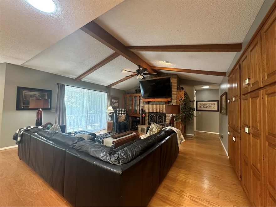 Amazing wall of art work! Amazing Location!  Center of Bella Vista! Bright, Close to Riordan/Kingsdale center with swimming pools, tennis, 2 golf courses, exercise, dining.  gathering in Riordan hall for community events and much more! Home is open & spacious living, dining, kitchen. lots of cabinets=lots of storage, a room just off the kitchen could be used as a great pantry or office! Family Rm/living area w/ high ceiling, wood beams, fireplace & wall of additional cabinets w/ hidden wet bar. Formal DR could be used as an Office. Extra large primary bedroom with large walk in closet. Primary bath Enjoy the large whirlpool tub and separate shower. Double vanity, tile floor.  Home used as a 3 bedroom but is on 2 Bedroom septic, extra living area with door has been used as 3rd Bedroom. Screened covered deck plus large open deck. Half bath in the utility room with sink. Extra large Garage. Nice sized tiled entry has nice light. Seller is motivated to move!