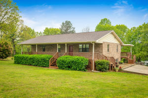 WONDERFUL COUNTRY SETTING FOR THIS BRICK HOME ON 3.12 ACRES!!! Check out all the amenities for this 3BR/2BA home that sits on pavement just outside of town! Home boasts many updates including a beautiful, newly remodeled Kitchen/Dining & Living Room! Walk out of the Kitchen onto the BRAND NEW, Large, Covered Deck that is FANTASTIC for entertaining! Big Master Bedroom & Bathroom that has 2 closet spaces! HUGE covered Front Porch that fits the setting perfectly & is great for that early morning coffee or late evening cocktail! Home also has a full, walkout, unfinished basement area that is great for storage or could be finished out to create even more livable space!