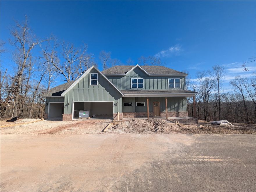 New construction with a 3 car garage and bonus room on a .46 acre wooded double lot next to the Back 40 Trail! This stunning property offers the perfect blend of nature and nearby amenities. Step inside to discover a beautiful fireplace, custom cabinets, gas range, and elegant 3 cm quartz countertops. This thoughtfully designed home features 3 spacious bedrooms plus a versatile bonus room, providing ample space for entertainment. The primary bedroom is conveniently located on the main level. Bentonville schools! As an added bonus, this home includes $3,500 in buyer's closing costs when using the builder’s preferred lender!