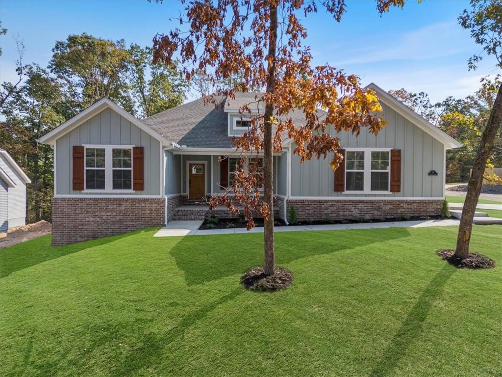 Beautiful new construction home on a generous .37 acre CORNER lot! Only two miles from the popular Tunnel Vision biking trail connection and six minutes to the Bella Vista Bypass, this property offers both convenience and access to nature. You will also be close to the proposed new bike chair lift, making this location perfect for those who love the outdoors. Inside, youāll find a well-planned split floor design with elegant finishes throughout. The open living space highlights vaulted ceilings with striking beams that add warmth and character. The kitchen is designed with quartz countertops, a gas range, custom cabinetry, and sleek black stainless appliances. The primary suite is a relaxing escape, featuring a spacious walk-in closet, a custom tiled shower, and soaking tub. Step outside to enjoy the covered deck, ideal for unwinding or entertaining. Ask your agent about the builderās preferred lender credit. Estimated completion date of October 20, 2025. Please note, photos are not of exact home/finishes.