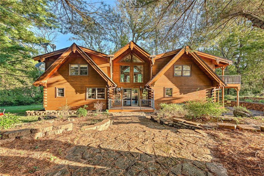 Discover this beautiful riverfront log home set on 25 acres with more than 1,400 feet of private river frontage just minutes from Eureka Springs, Arkansas. This property offers peace, privacy, & endless outdoor recreation opportunities.
The home features classic log construction with an open floor plan, vaulted ceilings, exposed beams, and large windows showcasing stunning river and woodland views. Enjoy cozy evenings by the wood stove or relax on the deck overlooking the water.
A 30x60 shop building provides plenty of space for vehicles, equipment, or hobbies. The land includes a mix of wooded areas and open meadows, ideal for trails, gardens, or future expansion.
Perfect as a full-time residence, vacation retreat, or investment property—this rare riverfront estate combines natural beauty w/convenience to one of Arkansas’s most charming towns.
As this property is managed in a fiduciary capacity By ARVEST Bank,Associates,Affilates and immediate family members should contract ARVEST Trust Compliance. Sold AS IS