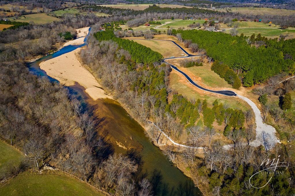 Enjoy the serenity of the beautiful crystal clear Kings River! This newly developed community is the perfect site for a weekend getaway or permanent dream home. Whether enjoying a lazy day floating the river, testing your skills on the blue ribbon smallmouth bass, or walking through the lovely community with panoramic mountain views, you can find your peace here. This building lot includes all underground utilities, Berryville City water, pre-approved septic, Windstream high-speed internet available, paved streets, and private Kings River access. Lot 5 does not front the river directly, but rather includes community river access with parking.