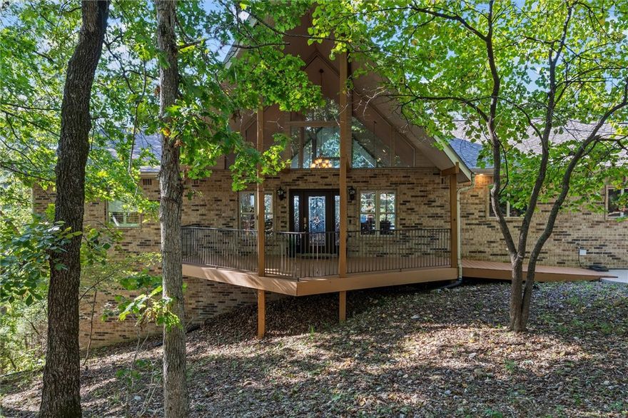 ULTIMATE LAKE ANN RETREAT! BIKE, LIVE, SAVOR: BACK 40 TRAIL ACCESS & 3+ SECLUDED ACRES OF LAKEFRONT PARADISE. This isn't just a house; it's the quintessential Northwest Arkansas lifestyle. Step out your door and connect directly to the legendary Back 40 Trail System. Bike miles before breakfast, then retreat to your private 4bed/4bath 4,092 sqft sanctuary. Breathtaking lake views from almost every single window, including the spectacular Home Office. Dual living spaces with TWO full kitchens, TWO laundry rooms, and TWO fireplaces. Perfect for seamless entertaining, multi-generational living, or a high-end short-term rental opportunity. Enjoy your morning coffee on one of the decks overlooking the lake. Follow the paved path down to your charming Lakeside Gazebo. Direct Lake Access with your very own Fishing Dock. The famous bluffs of Lake Ann are literally on your property! This is more than a home; it's a Prized Piece of Real Estate offering seclusion, land, and access to world-class​​‌​​​​‌​‌​​​‌‌​​​‌‌‌​​‌​​‌‌​​​​ recreation.