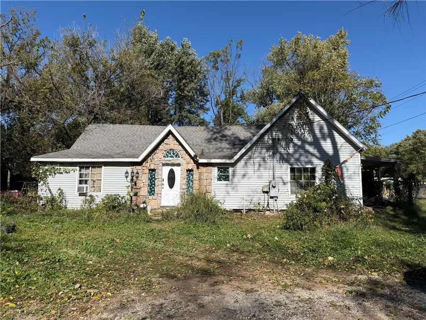 Fantastic location in the heart of Gravette! This charming home sits directly across from the school and is just steps away from local restaurants, banks, and grocery stores—making everyday convenience a breeze. Situated on a spacious lot with two driveways, this property offers great potential inside and out. A true fixer-upper’s dream, it features a large open living room with plenty of space to customize and make it your own. The motivated seller is ready to move quickly as the sale is contingent on another home. Don’t miss the opportunity to turn this property into something special in one of Gravette’s most convenient locations!  Being sold AS IS.