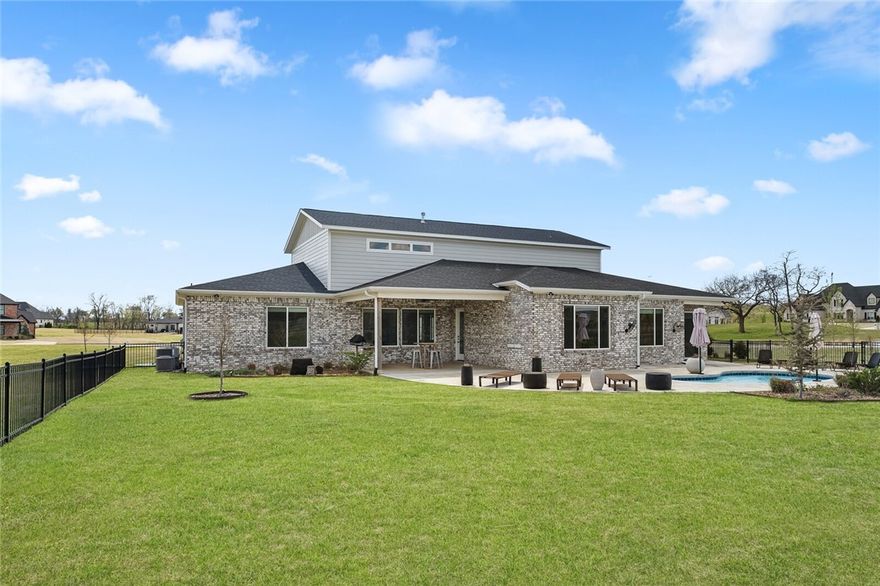 Modern Contemporary home on an acre lot in the prestigious West End subdivision in Centerton, 5 miles from Wal-Mart HQ & downtown Bentonville. This home features 4 beds downstairs with a split floorplan. Master bedroom is spacious. Master bath has separate vanities, a custom walk-in shower, modern jetted free standing tub, and oversized walk in closet connected to the laundry room, & a bonus/flex space area designed with an oversized exterior door for with easy access for fitness equipment. 3 remaining bedrooms downstairs, all have walk in closets and en suites. The "oversized" 5th bedroom, upstairs with en-suite, can be used for a large gameroom. Living room showcases 25 ft ceilings that provide an abundance of natural light, wood floors throughout living areas. 
Kitchen has Cafe' appliances, gas oven & stove-top. 2 bonus/office rooms downstairs. ECOBEE smart thermostat w/room temperature monitors. Abundant attic storage. Covered patio kitchen area, heated Gunite pool, fenced backyard, outdoor landscape lighting.