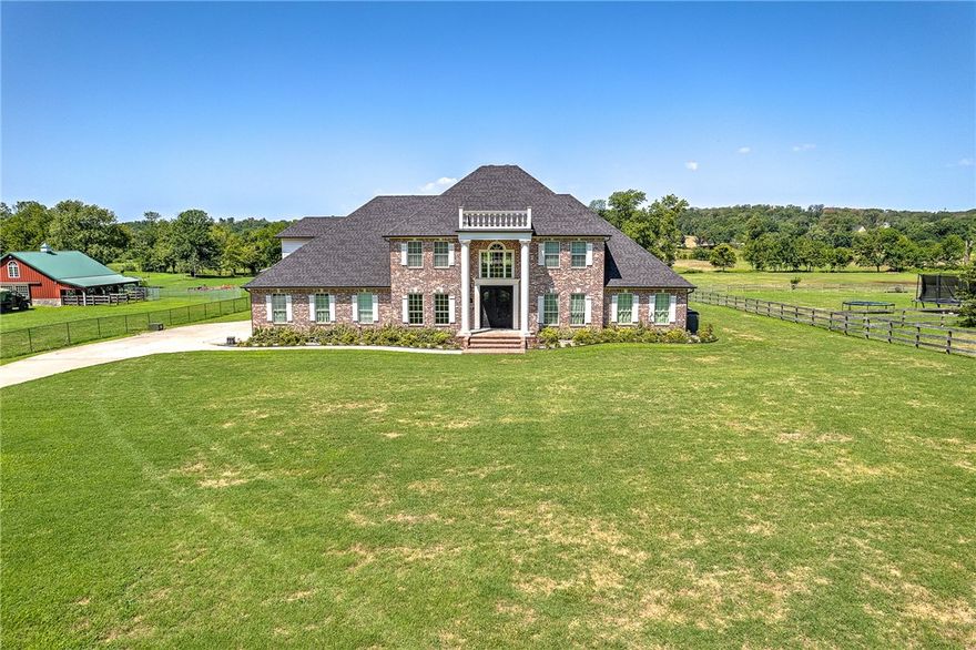 Beautiful estate located in Little Osage Creek Valley w/ 144’ of creek running through the back of the property. Situated on 5.59 acres in a highly desirable location, this stunning brick home has the timeless sophistication you looking for in a peaceful and serene setting. Upon entering, the high ceilings & split staircase are show stoppers. A wall of windows invites you to enjoy the beautiful views of nature while allowing an abundance of natural light. Chef’s will love the oversized, eat-in kitchen with dbl ovens, walk-in pantry, & induction cooktop. Enjoy sunsets from the back deck & the warmth of the pellet stove in the winter.  Water filtration system & purification system w/ reverse osmosis throughout the house. 3,200 sq. ft. (40x80) steel truss, insulated, shop with 1/2 bath, air compressor, car lift, utility sink, washer/dryer hook-up, multiple 220V outlets, & built in work benches.  Income producing potential w/ separate meter.  320 yard rifle & pistol range w/ backstop.  Bridge for easy access to creek.