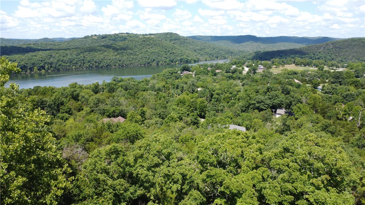 Looking for a nice building lot in Holiday Island with a view? This might be it! This .45 acre lot is located on Quail Run Drive, which is on the Island in Holiday Island & super close to everything Holiday Island has to offer. The new recreation center, swimming pools, pickle ball courts, and golf course are 1/2 a mile away and the Holiday Island Marina is only a mile away. So you can either rent a golf cart for the day or rent a boat for the day and either way, you are set. The lot itself has an uphill slope and has some unique rock formations giving your land a little extra character. With the slope of the land and the style of house you will build, you will have one awesome view of Table Rock Lake! Electric, Water, & Sewer are at the street which helps out with the construction costs. The sellers bought this property in 2024 to build on but ended up finding the perfect home in Holiday Island to purchase so they are just trying to recoup their money. Someone take this off their hands!
