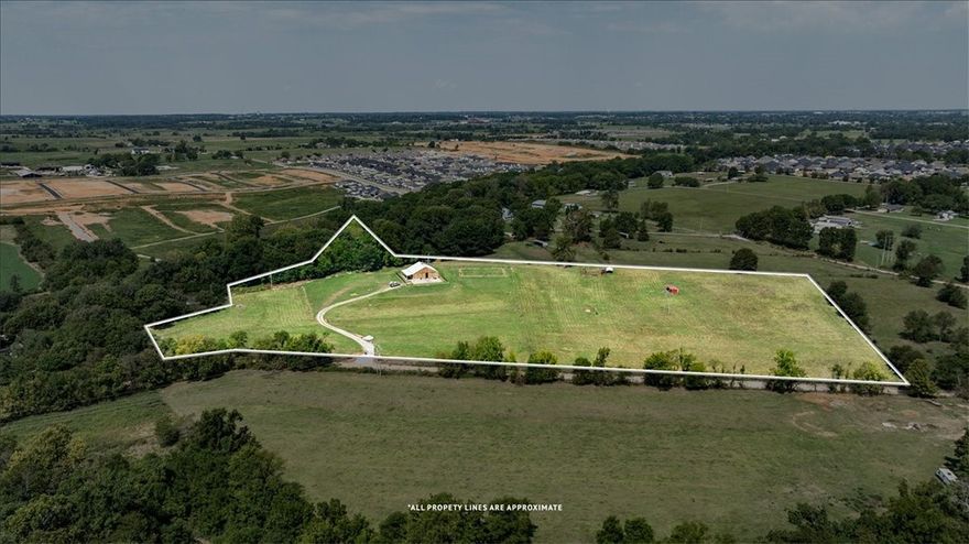 Investor Opportunity: Prime Subdivision Land in Bentonville Presenting a unique investment opportunity! This beautiful nearly 15-acre parcel of land is located right in Bentonville, offering the perfect blend of rural charm and modern convenience. Natural Setting: The property backs up to Osage Creek, providing a serene environment that's ideal for a country lifestyle. Ready for Use: Featuring a barn equipped with essential amenities and a functional barndominium that is ready to move in; with ample space for parking a full-size RV inside. It also features a full size generator. Agricultural Potential: Ample space for raising cattle, complemented by an industrial-sized freezer for efficient meat storage. Convenient Location: Experience the tranquility of country living while being just five minutes away from the nearest store. Don’t miss this opportunity to invest in a diverse and promising piece of land in a thriving community. For inquiries or to schedule a visit, please contact us!