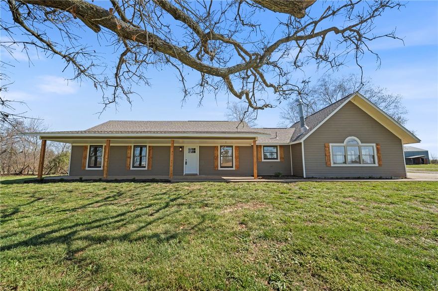 Welcome to your private slice of NWA living in Bentonville! Situated on 2.4 wide-open acres—with additional acreage available—this beautifully updated home offers space, freedom, and versatility. The mostly cleared pasture land creates an expansive setting with long sightlines and endless possibilities, whether for a hobby farm, horses, gardening, or simply enjoying privacy and open space, with plenty of usable land to make it your own. Inside, a light-filled layout features modern finishes throughout. The kitchen shines with quartz countertops, an electric cooktop, and double oven—perfect for everyday living or entertaining. The main level offers luxury vinyl plank flooring with tile in the bathrooms, while upstairs features hardwood floors and a unique loft with its own bathroom. Recent updates include a new roof (07/2025) and HVAC (03/2026). Outside, a 34x32 metal shop adds space for storage, hobbies, or workspace. Enjoy country-style freedom just minutes from Bentonville amenities.