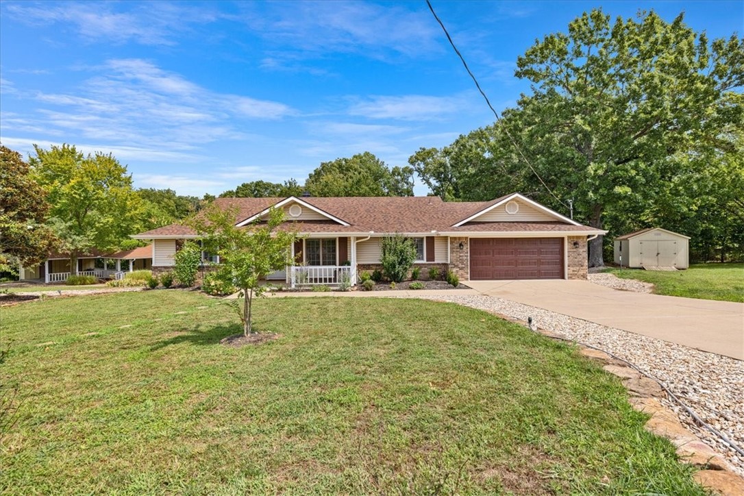 Enjoy immediate access to the Tunnel Vision bike trail from this nearly half-acre flat corner lot located in an established neighborhood with charming homes. This 2-bed, 2-bath split floor plan includes a private office, vaulted ceiling living room with new smart pellet fireplace, and kitchen with pantry, ample cabinets, and brand-new luxury appliances including a gas stove. Major updates: new roof (2023), HVAC, pellet stove, plumbing, Wi-Fi enabled belt drive garage door, and more offer peace of mind for years to come. Outdoor living features a large deck, landscaped yard, fenced area, and a 12x24 outbuilding. Oversized 2-car garage with attic storage. Convenient to Bella Vista lakes, golf, and trails with quick I-49 access—only 20 minutes to the new Walmart Home Office!