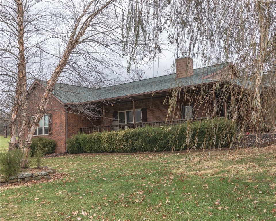 You won't believe this fantastic property - it has it all! This is one beautiful home on 7.42 acres with a fantastic view, only 3.5 miles from Hwy 62 on a paved road. It offers 3,743 SF of living space, 5 bedrooms and 3 full baths, a 2-car attached garage, plus a 26x40 brick detached 3-car garage (wired) and a nearly new 24x30 metal building as well. The interior of the home is in fantastic condition. The kitchen includes 2 large pantries and a pellet stove for ambiance in the dining area. Tremendous yard and paved driveway coming through a deeded easement from the road. You must see this one to appreciate it!