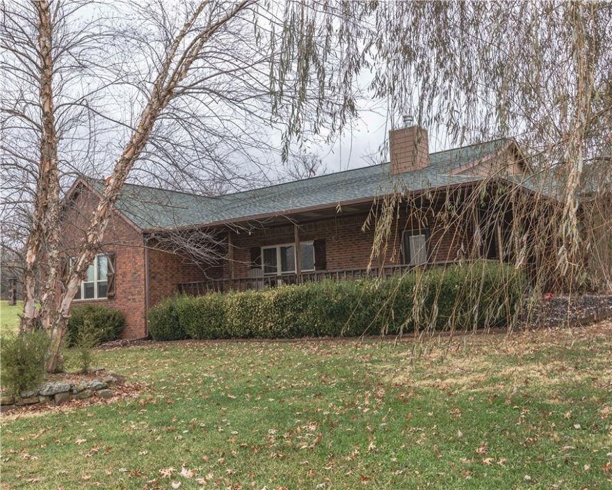 You won't believe this fantastic property - it has it all! This is one beautiful home on 7.42 acres with a fantastic view, only 3.5 miles from Hwy 62 on a paved road. It offers 3,743 SF of living space, 5 bedrooms and 3 full baths, a 2-car attached garage, plus a 26x40 brick detached 3-car garage (wired) and a nearly new 24x30 metal building as well.  The interior of the home is in fantastic condition. The kitchen includes 2 large pantries and a pellet stove for ambiance in the dining area. Tremendous yard and paved driveway coming through a deeded easement from the road. You must see this one to appreciate it!