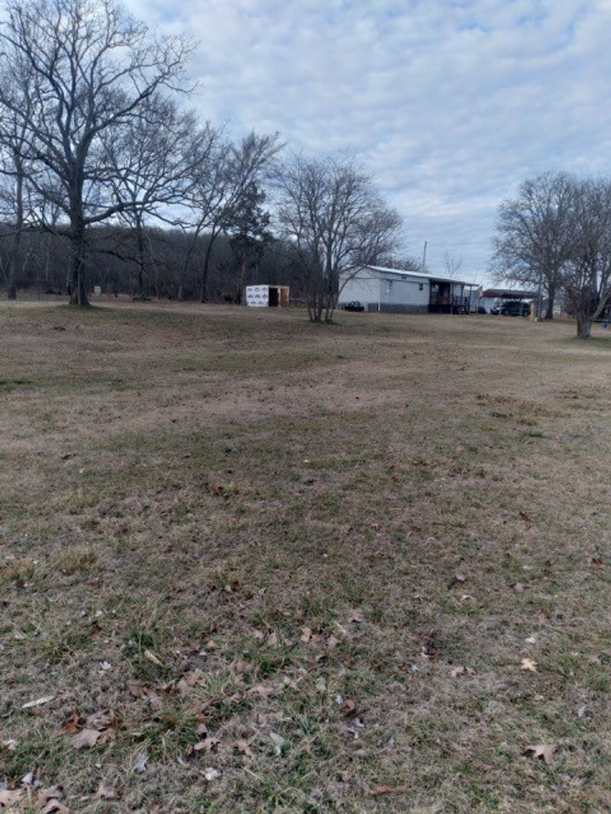 Great location! 1.69 Acres residential property with 465 feet Highway 62 and Heritage Parkway frontage. Property contains a well taken care of 784 SF mobile home. Call for a showing today!