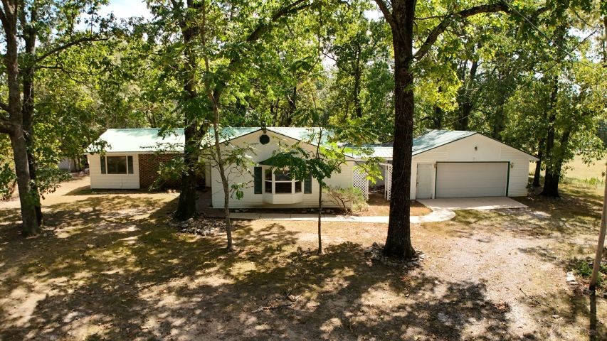 Charming 3 bedroom, 2 bathroom home situated on 6.99 acres just minutes from Mountain Home, Norfork Lake, and the White River. Home features a bright sunroom, spacious deck, and an attached 2-car garage. A large barn/shop on the property provides excellent space for storage, hobbies, or workspace. Perfect for those seeking peaceful country living with easy access to outdoor recreation.