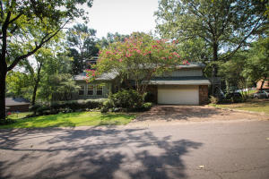 Surrounded by nature in a peaceful, forested neighborhood that feels like living in a treehouse when looking out the many windows on the main level. Plenty of room to entertain in the spacious living/dining room and back deck overlooking the extra lot. Seller says plenty of wildlife and yet just 5 minutes from shopping, groceries, downtown and the hospital. It is a comfortable, welcoming custom built home with stately character. No cookie cutter feel here. The storage, closet and bathroom space is abundant and amazing. Master Bedroom on the main floor with two walk-in closets. Two bedrooms on the 2nd floor with jack and jill bathroom and a walk-in closet for each bedroom. The third bedroom (a second Master Bedroom) has a very private feel with its own ensuite bath and a private deck.
