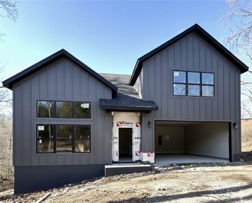 Modern new construction home on a large .36-acre wooded lot! 3 bedrooms / 2.5 baths + bonus. Just down the street from the Back 40 Trailhead Crossing! Step into a bright and airy interior featuring tall ceilings and a striking 2-story fireplace. The kitchen boasts custom cabinets, floating shelves, gas range, and 3 cm quartz countertops. The primary bath features a luxurious soaking tub and a walk-in tile shower. Enjoy abundant natural light throughout, and entertain on the spacious deck overlooking the serene landscape. High-end finishes throughout. Located just minutes from Lake Ann! Bentonville schools! As an added bonus, receive $3,500 towards buyer's closing costs when working with the builder’s preferred local lender! Schedule your showing today!