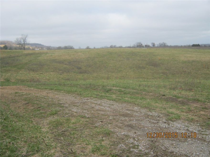 various topography creek and pond.  There is a barn on the property. Property is fenced and cross fenced.