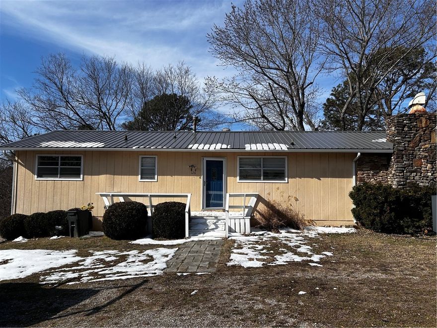 Centrally located 2 bed 2 bath home move in ready. 
New metal roof and separate heating systems plus a large wooden fireplace. Turn the walkout basement into another living quarters. Basement has separate HVAC.
Gas range and cooktop for even cooking. Serve your meals on the back deck for lounging and listening to town. 
Close to amenities of town, minutes from downtown. 
Septic recently serviced and cleaned. Washer, dryer, and fridge convey.